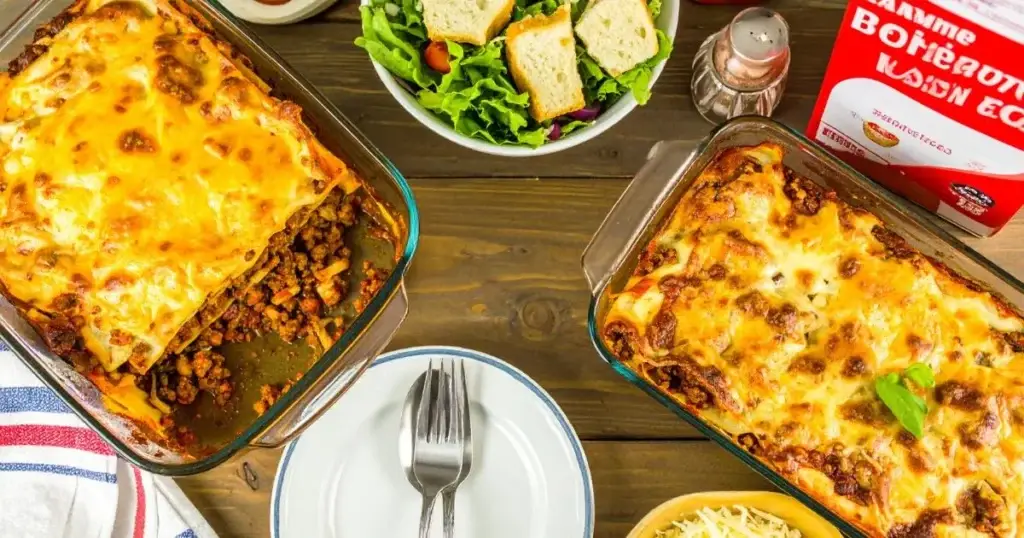 Freshly baked American Beauty lasagna recipe in a glass dish with golden melted cheese, visible layers of noodles, meat sauce, and ricotta, garnished with fresh basil, served on a rustic kitchen table with salad and garlic bread.