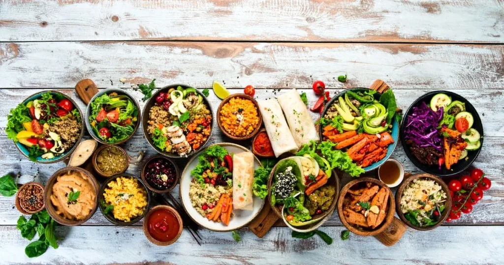 Gluten Free Lunch Ideas displayed in a colorful overhead spread, featuring quinoa bowls, lettuce wraps, stuffed bell peppers, and veggie-based meals on a rustic table.