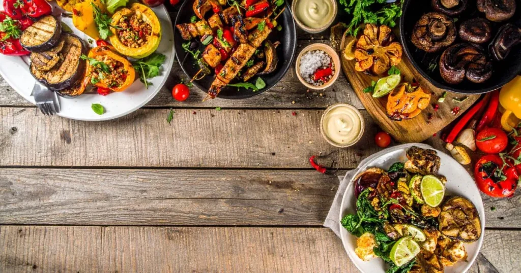 Traeger Vegetarian Recipes featuring smoky grilled portobello steaks, maple-glazed acorn squash, quinoa-stuffed peppers, and wood-fired seasonal vegetables packed with flavor.