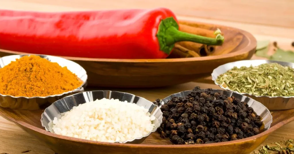 Corned beef spices in glass containers with wooden spoons