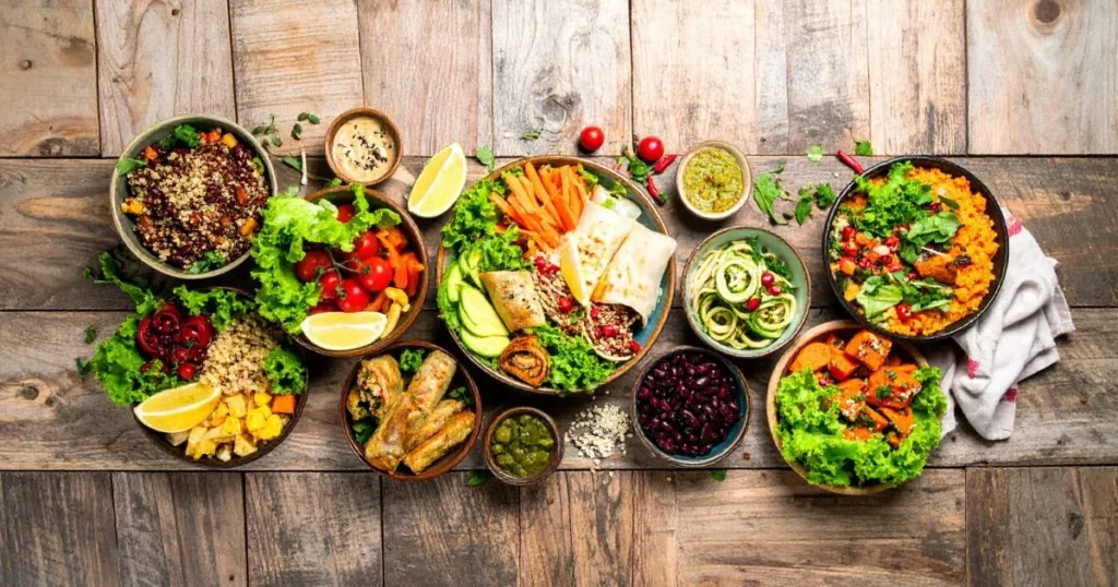 Gluten Free Lunch Ideas displayed in a colorful overhead spread, featuring quinoa bowls, lettuce wraps, stuffed bell peppers, and veggie-based meals on a rustic table.