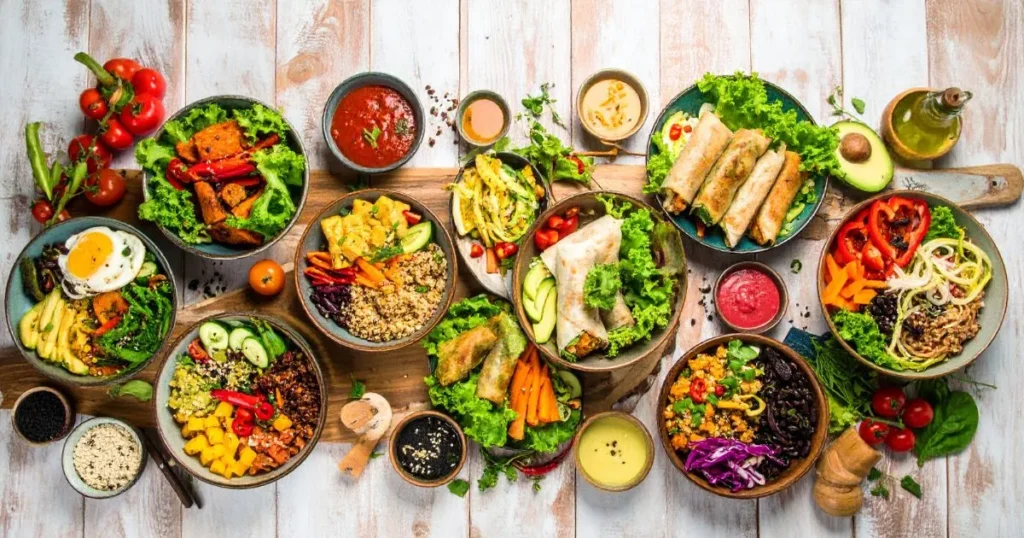 Gluten Free Lunch Ideas displayed in a colorful overhead spread, featuring quinoa bowls, lettuce wraps, stuffed bell peppers, and veggie-based meals on a rustic table.