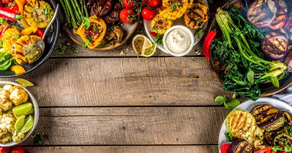 Traeger Vegetarian Recipes featuring smoky grilled portobello steaks, maple-glazed acorn squash, quinoa-stuffed peppers, and wood-fired seasonal vegetables packed with flavor.