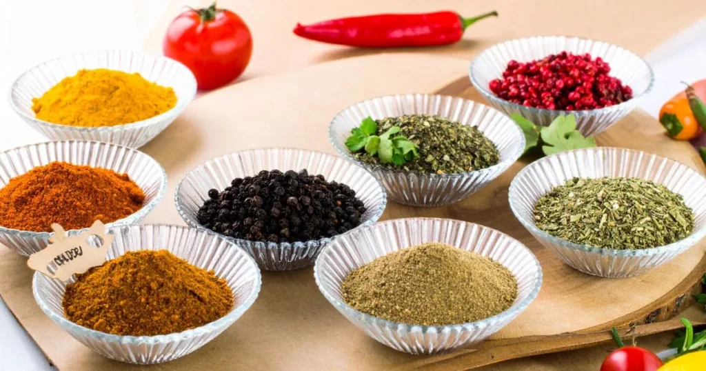Corned beef spices in glass containers with wooden spoons