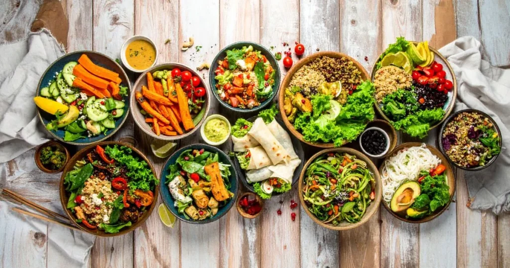 Gluten Free Lunch Ideas displayed in a colorful overhead spread, featuring quinoa bowls, lettuce wraps, stuffed bell peppers, and veggie-based meals on a rustic table.