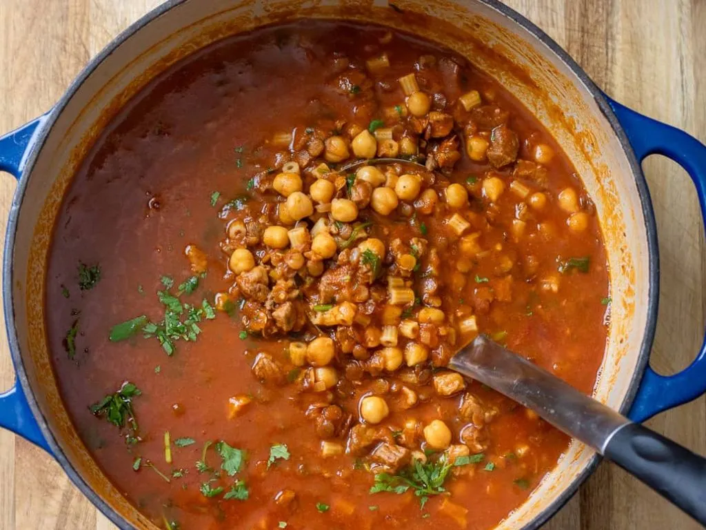 Bowl of traditional Moroccan Harira soup with lentils and chickpeas