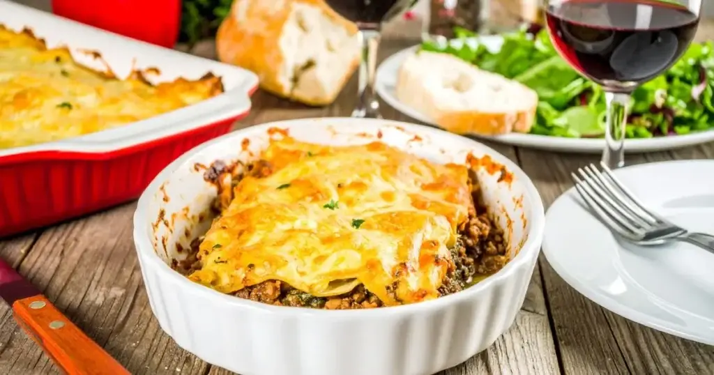 A close-up of a freshly baked lasagna with golden cheese and visible layers, representing an Authentic Lasagna Bolognese Recipe.