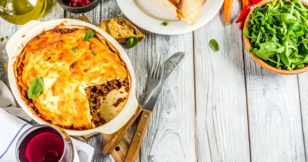 A close-up of a freshly baked lasagna with golden cheese and visible layers, representing an Authentic Lasagna Bolognese Recipe.
