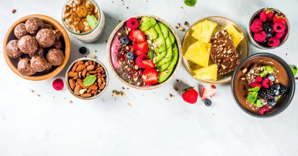 Sweet breakfast ideas featuring five no-bake dishes like parfaits, chia pudding, energy balls, and mousse on a bright table.